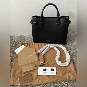 Burberry black medium size tote with crossbody strap included.
